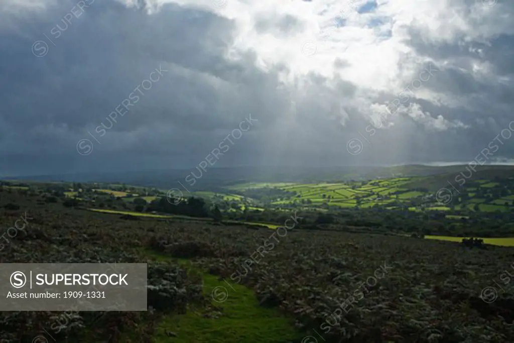 Shafts of sunlight on Dartmoor near Widdecombe-in-the-moor on a stormy summers day Devon England United Kingdom GB Great Britain British Isles Europe EU