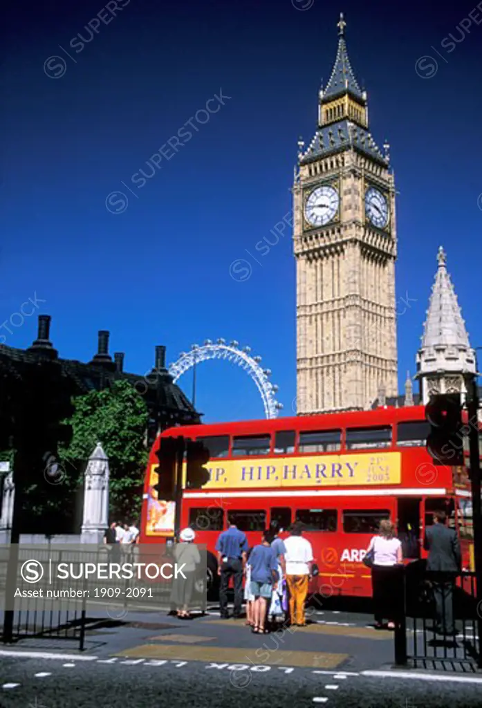 Big Ben and the London Eye by the Houses of Parliament with tourists and a red bus in London the capital city of England United Kingdom UK Great Britain GB Europe