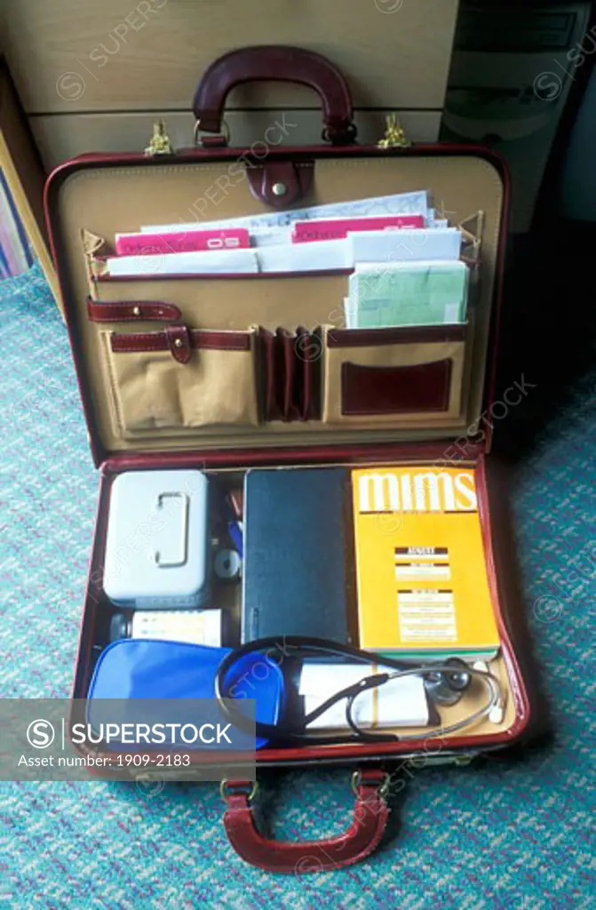 Medical doctors bag with sphygmomanometer stethoscope auriscope and Mims magazine