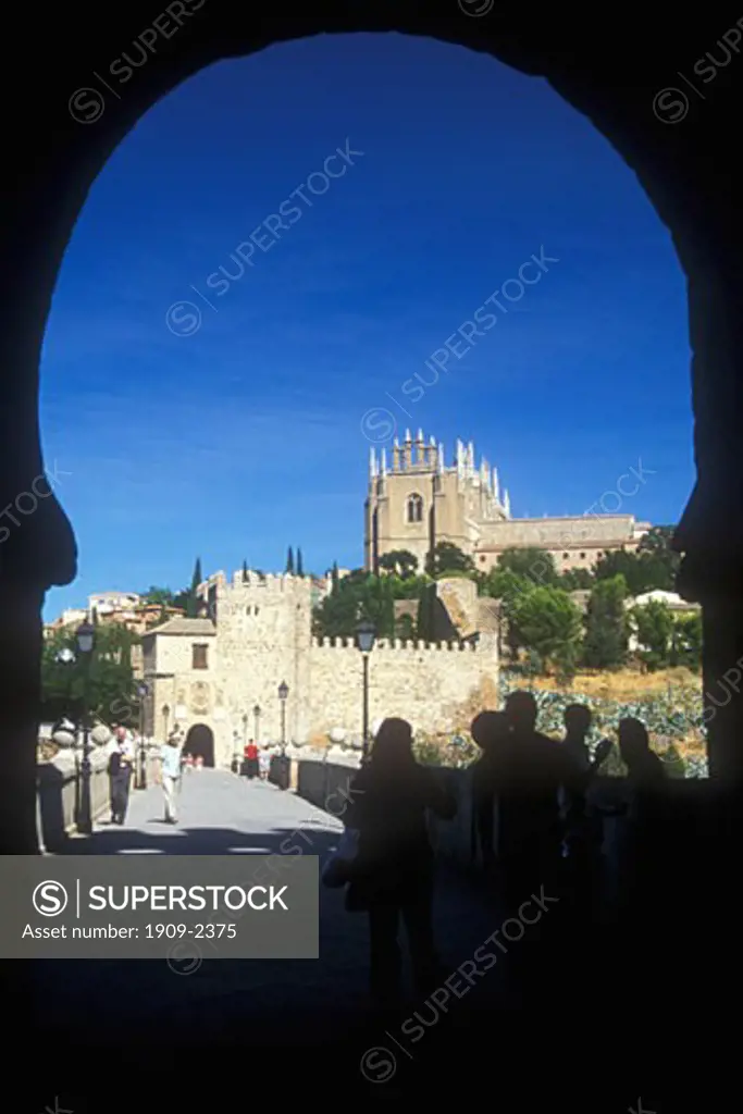 View of the cathedral and ancient city of Toledo through the moorish arch of the San Martin Bridge Toledo Castile Spain Espana Europe EU