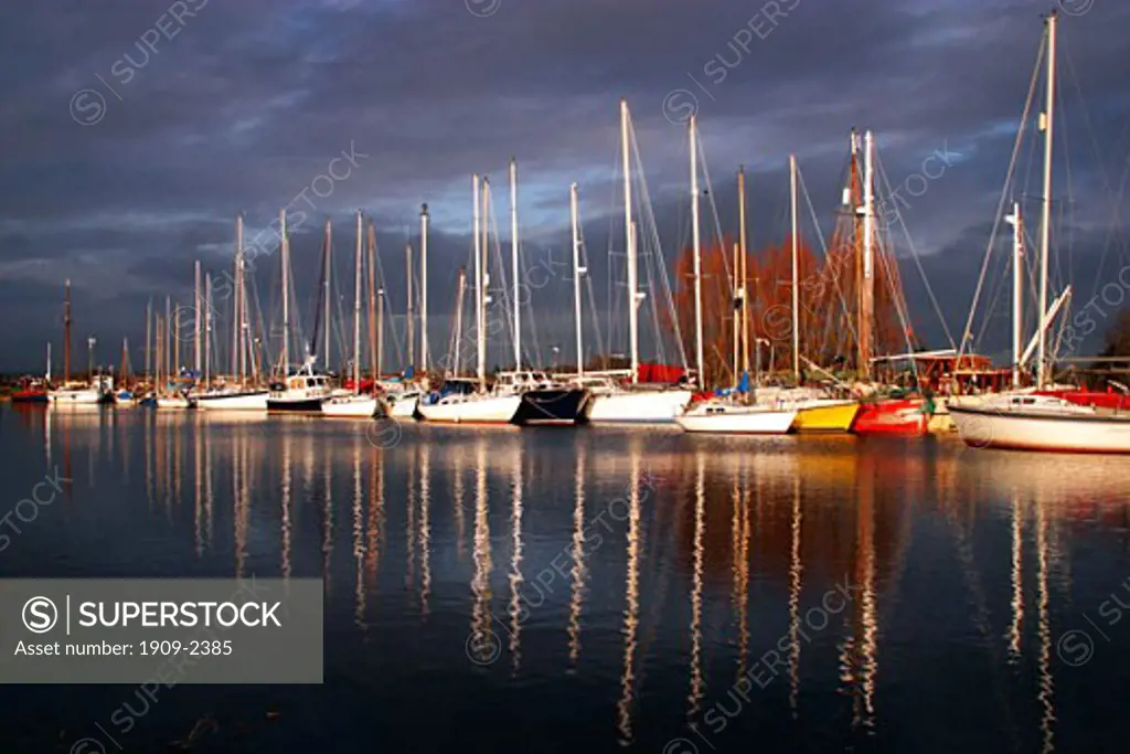 Exeter Canal near Turf Locks with sailing boats and reflections on the water in winter sun Exe estuary near Exmouth Exeter Devon South West Southwest England UK United Kingdom GB Great Britain British Isles Europe EU