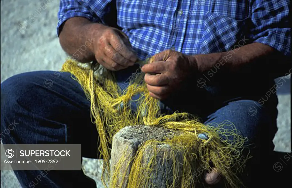 Greek Islands fisherman mending nets Cephalonia Kefalonia Ionian sea Greece Europe