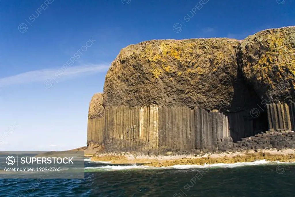 Isle of Staffa taken from tourist pleasure boat trip to island in summer sun sunshine with blue sky Argyll Inner Hebrides Scotland UK United Kingdom GB Great Britain British Isles Europe EU The island is famous for its basalt columns and Fingals Cave