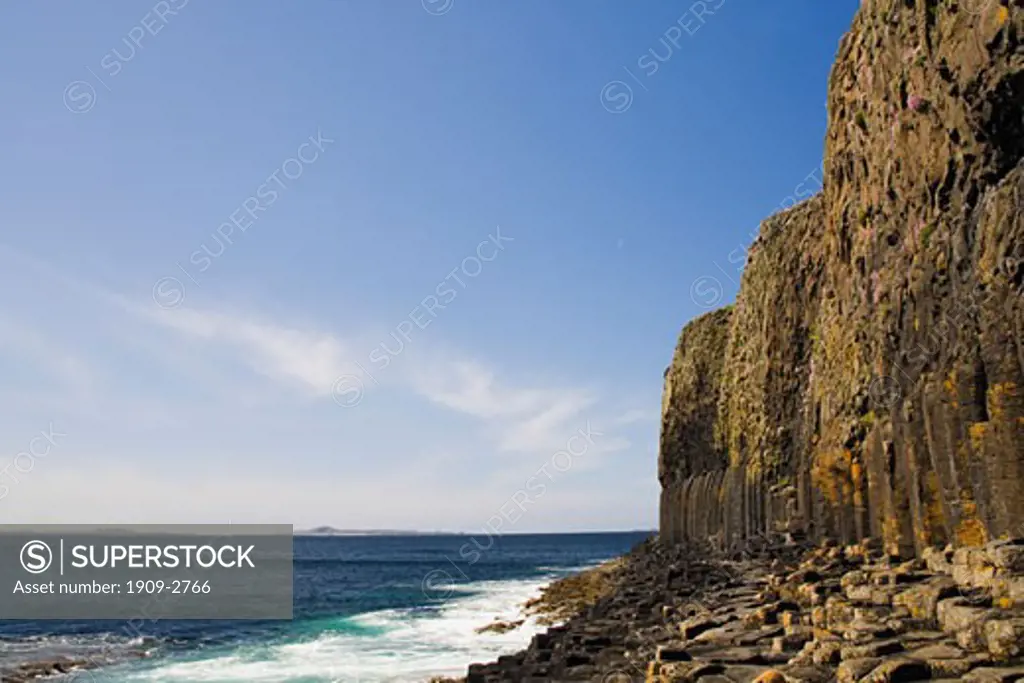 Isle of Staffa in summer sun sunshine with blue sky showing basalt columns and footpath along the cliffs to Fingals Cave Strathclyde Argyll Inner Hebrides Scotland UK United Kingdom GB Great Britain British Isles Europe EU