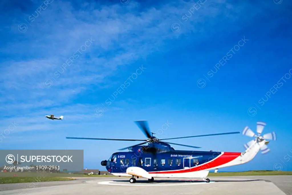 Helicopter landing at St Marys Airport on the Isles Of Scilly Cornwall England UK United Kingdom GB Great Britain British Isles Europe EU