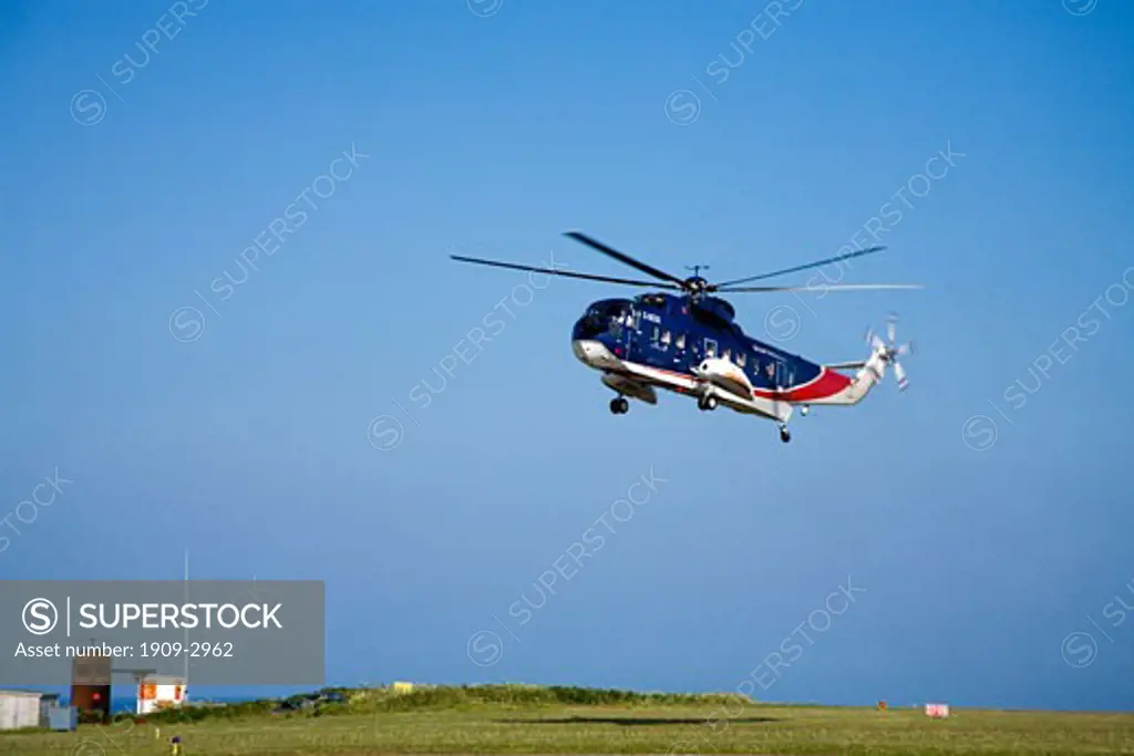 Helicopter landing at St Marys Airport on the Isles Of Scilly Cornwall England UK United Kingdom GB Great Britain British Isles Europe EU