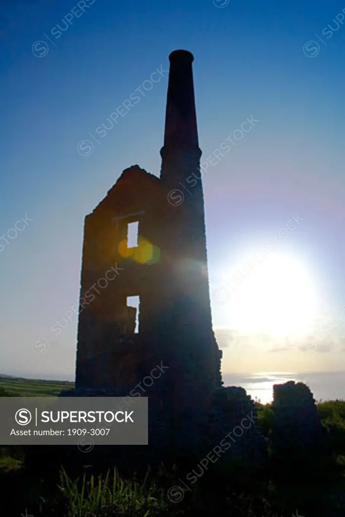 Ruined cornish engine house of Carn Galver Copper Mine in summer sunshine on the Atlantic Ocean with chimney at Bosigran West Penwith Cornwall England UK United Kingdom GB Great Britain British Isles Europe EU