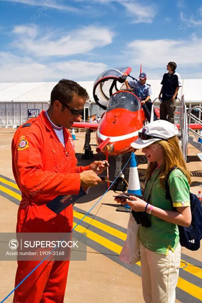 Red Arrows RAF aerobatic display team pilot signs autograph for lucky young girl at Fairford International Air Show 2006 Gloucestershire England Great Britain GB United Kingdom UK British Isles