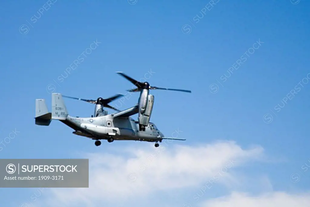 Bell Boeing V-22 V 22 V22 Osprey tiltrotor aircraft flying in blue skies at the RAF International Air Show in Fairford Gloucestershire in 2006The aircraft takes off and lands like a helicopter but once airborne converts to a turboprop airplane