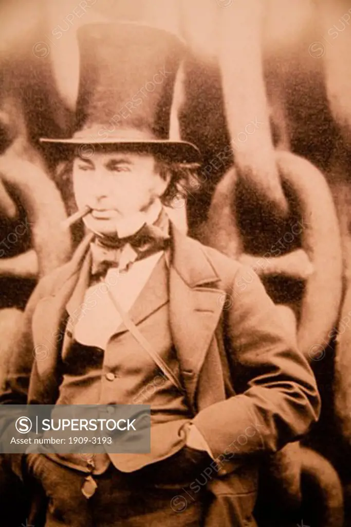 Photograph of Isambard Kingdom Brunel the famous english victorian engineer and inventor in an iconic pose with billycock top hat in front of chains used in the launch of the Great Eastern at Millwall in 1857