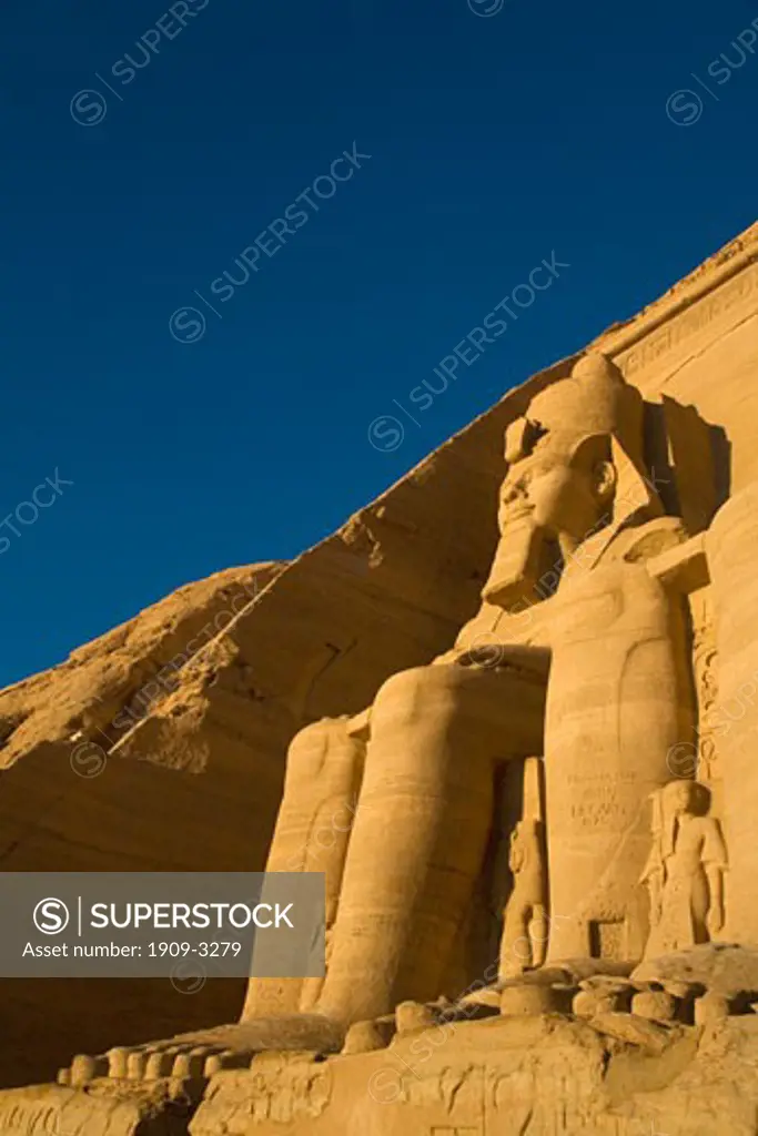 Abu Simbel Great Temple entrance with Statue of Ramses II in early morning sun sunshine Egypt North Africa