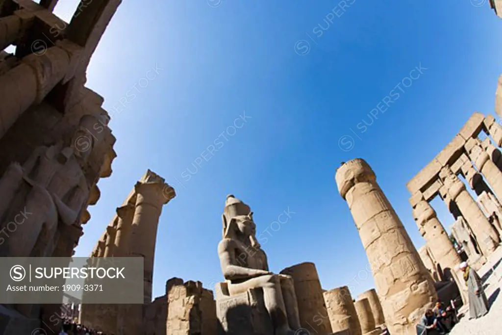 Statue of Ramses II in summer sun sunshine Karnak Temple Luxor Egypt Africa Karnak Temple is the largest temple complex ever built and was gradually enlarged by successive pharoahs over a thirteen hundred year period