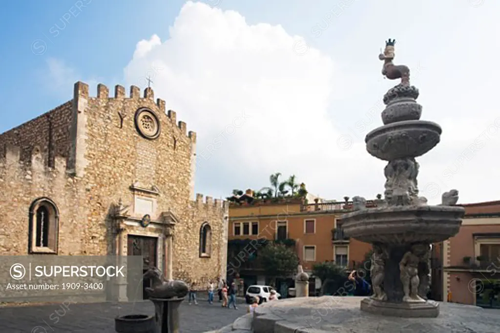 Mermaid fountain in Piazza Duomo town square with Cathedral  of Saint Nicholas in summer sun sunshine Taormina Sicily Italy Europe EU