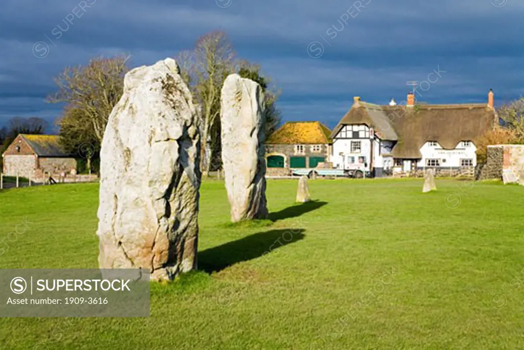 Avebury Stone Circle and english pub Red Lion public house with standing stones in spring winter sun sunshineWiltshire England UK United Kingdom GB Great Britain British Isles Europe EU