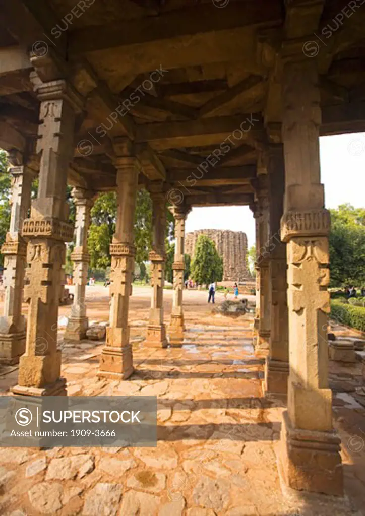 Unfinished Alai Minar tower at the Qutub Qutb Minar Complex UNESCO World Heritage 12th - 13th century with courtyard and carved stone pillars Delhi India Asia