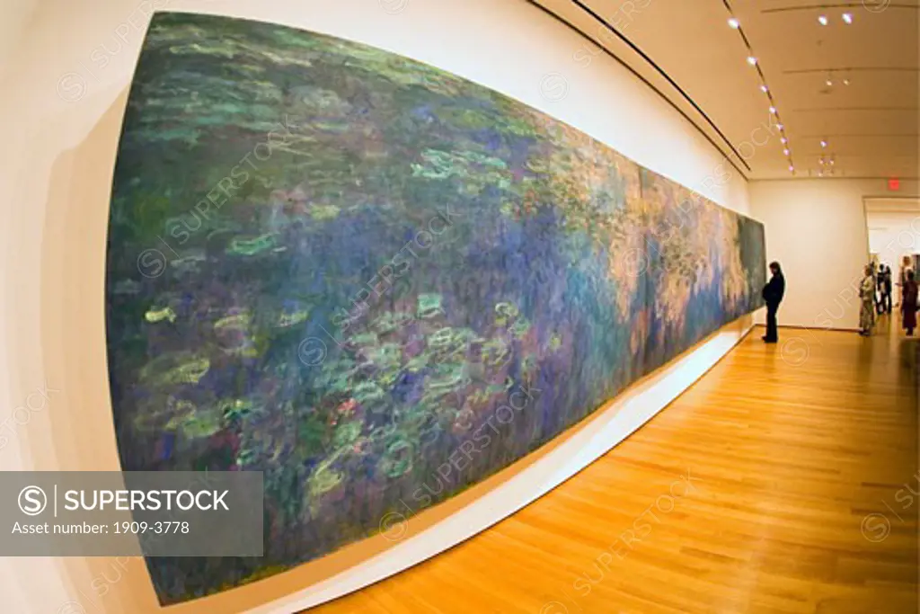 MOMA Museum of Modern Art interior with woman  admiring the painting of waterlilies by Claude Monet fisheye lens midtown Manhattan New York City NY NYC USA United States of America North This image replaces ABNM1W