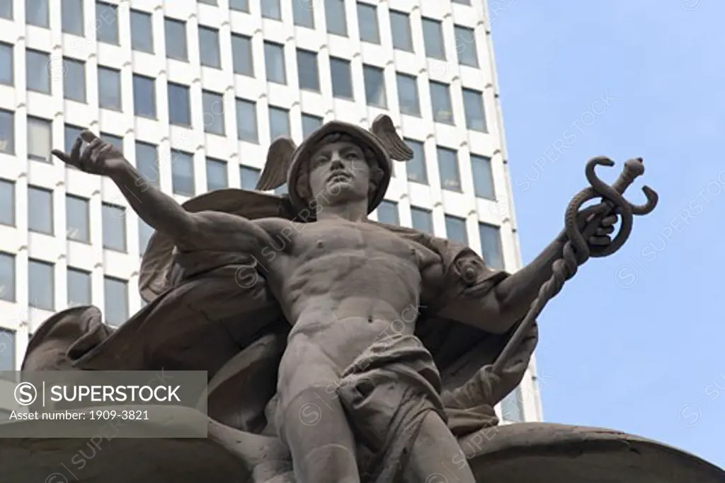 Grand Central Terminal train station statue of Mercury the greek god in sun sunshine with blue sky against the Met Life building midtown Manhattan New York City United States of America USA