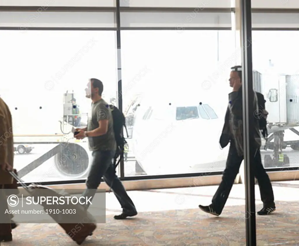 Travelers departing from aircraft  walking along corridor  Calgary International Airport  Canada  Alberta  Calgary