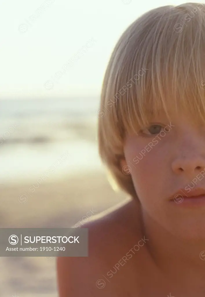Portrait of young boy 6 yrs tired after a long day on the beach  Spain  Andalucia