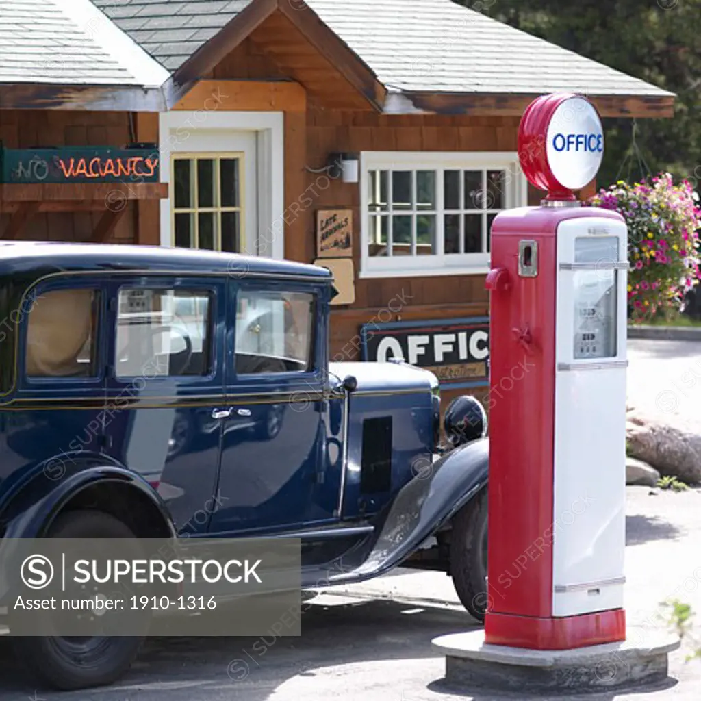 Old car parked alongside nostalgic gas pumps at Johnson Canyon near Castle Mtn Banff Natl Park CANADA Alberta