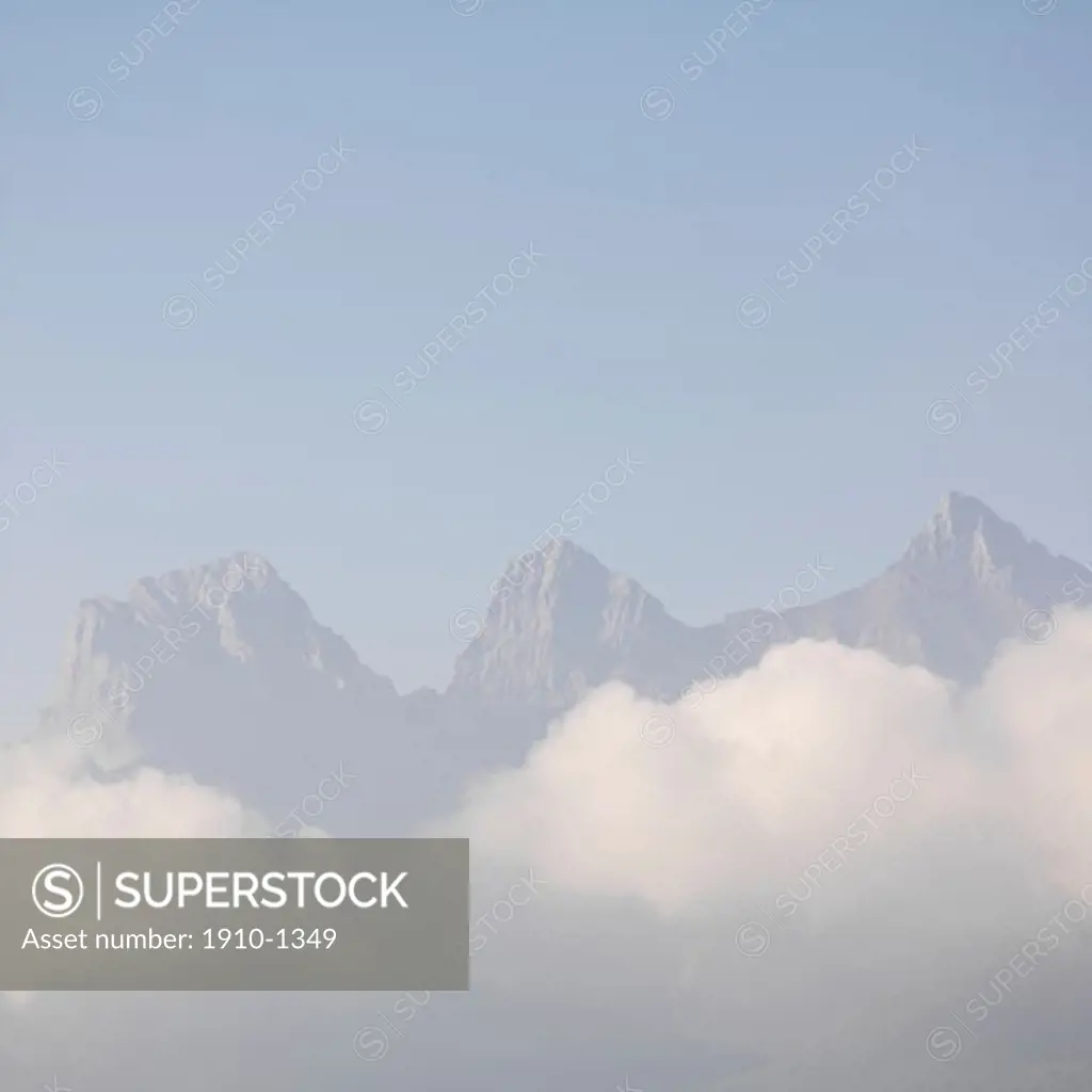 Three Sisters Mountain with morning clouds rising above Canmore CANADA Alberta