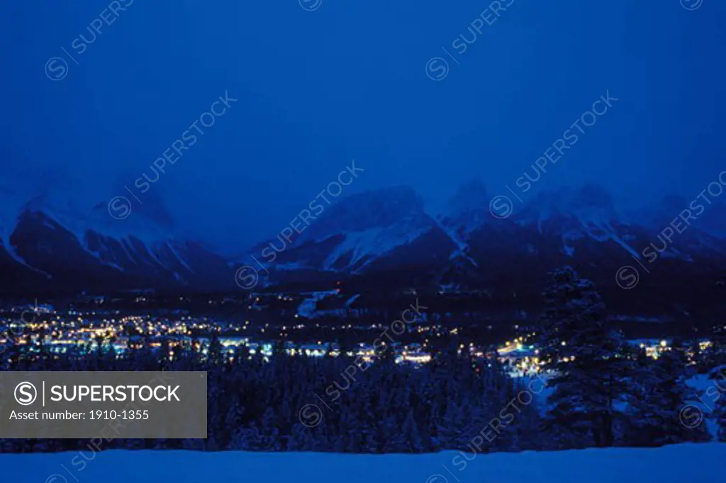 Overview of Canmore on cold winters night with Ha Ling Peak and Rundle Range behind CANADA Alberta