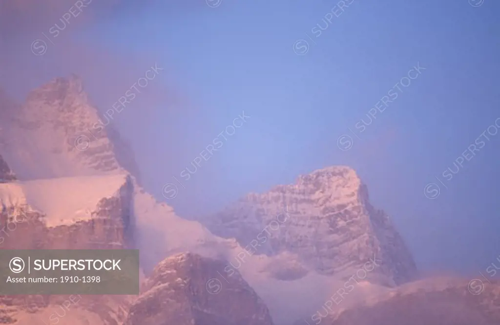 Rundle Range with snow and morning clouds rising above Canmore CANADA Alberta