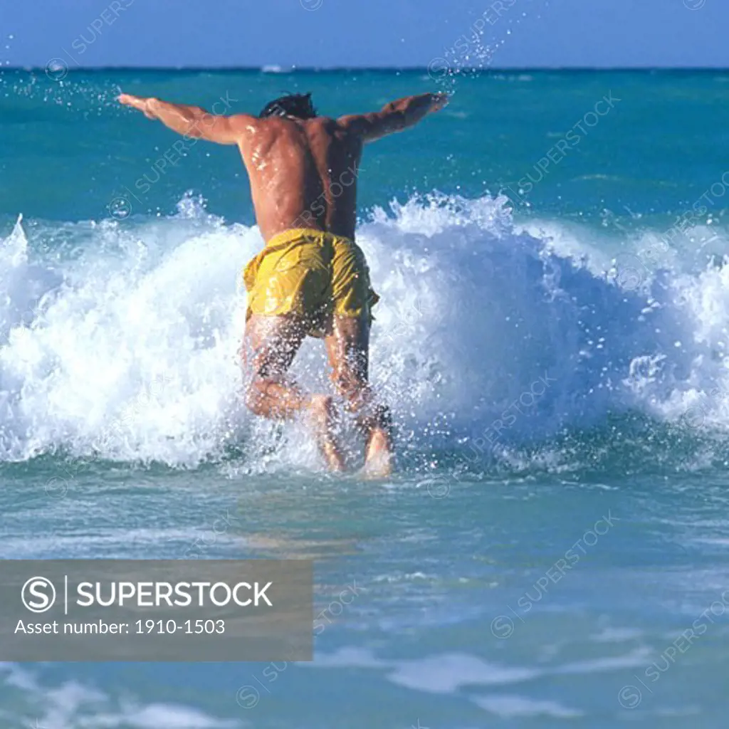 Man leaping into warm surf water Varadero is a resort town in the province of Matanzas Cuba and one of the largest resort areas in the Caribbean Varadero is also called Playa Azul CUBA Varadero