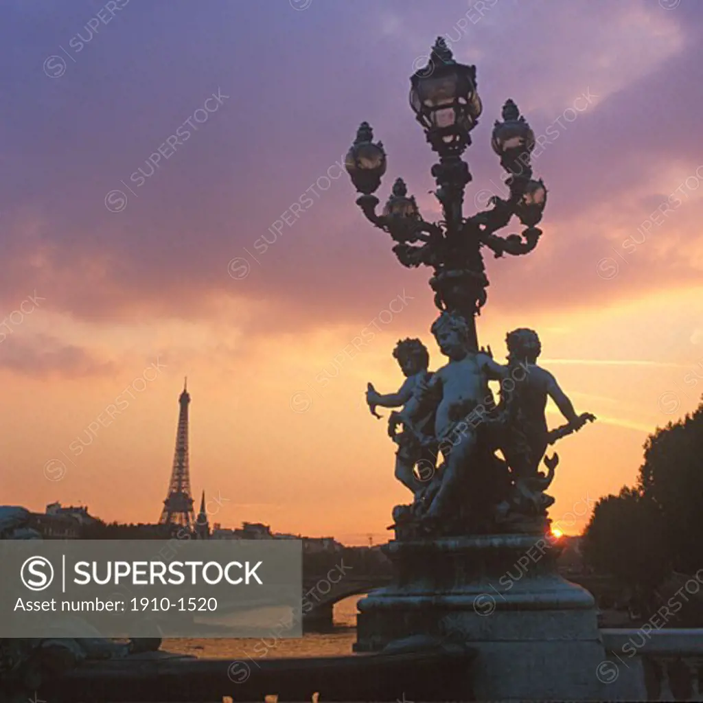 Statues on Alexander III bridge and distant Eiffel tower River Seine below FRANCE Paris