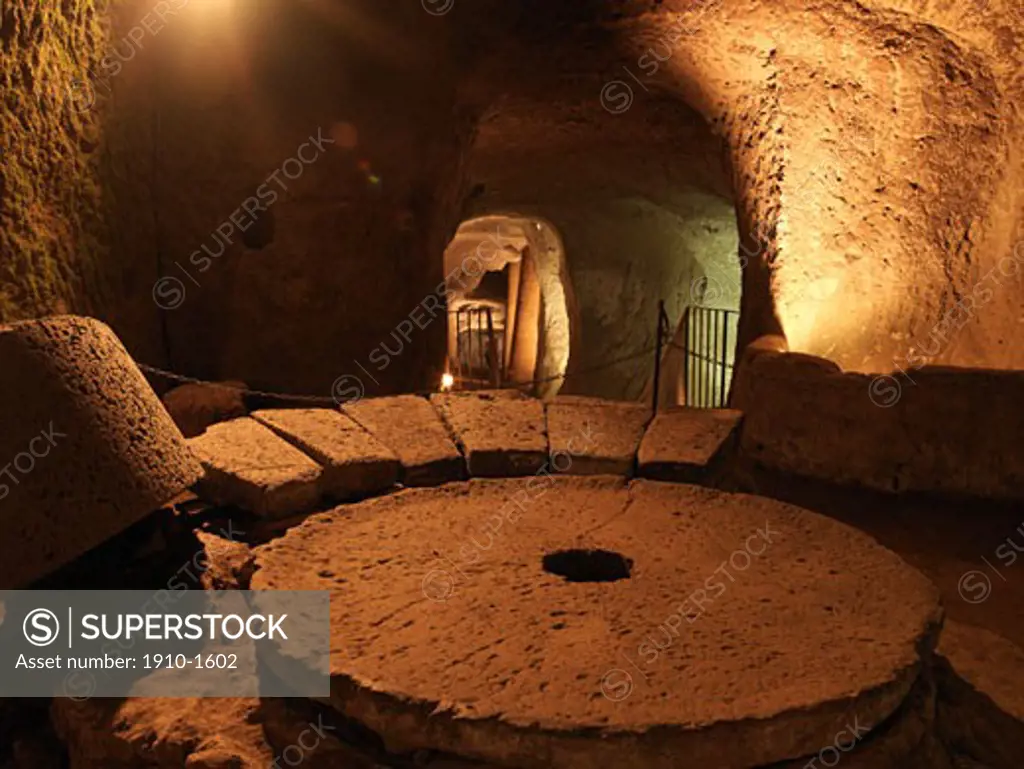 Part of cave complex of Orvieto showing grinding wheel The site of the city is among the most dramatic in Europe rising above the almost-vertical faces of volcanic tuff cliffs that are completed by defensive walls built of the same stone ITALY Umbria