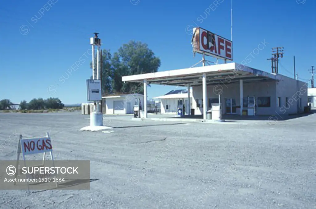Gas station and caf with signage warning east of Barstow Mojave Desert USA California