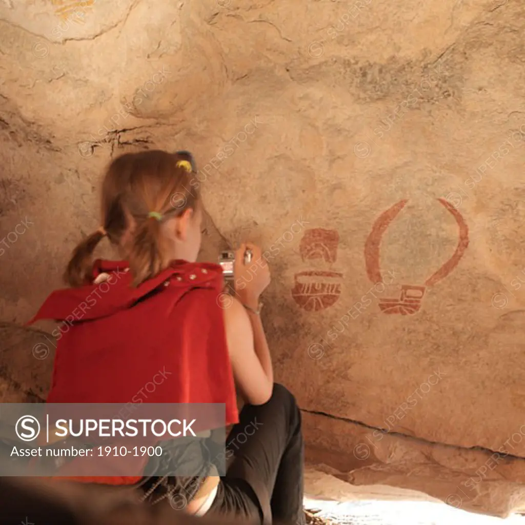 Girl 10 photographing cave paintings Hueco Tanks Sate Park USA Texas