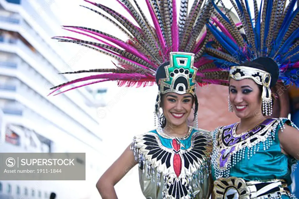 22 year old Hispanic sisters  Aztec outfits  feather head dress with Pheasant feathers  Cruise Ship Terminal  Mazatlan  Sinaloa State  Mexico