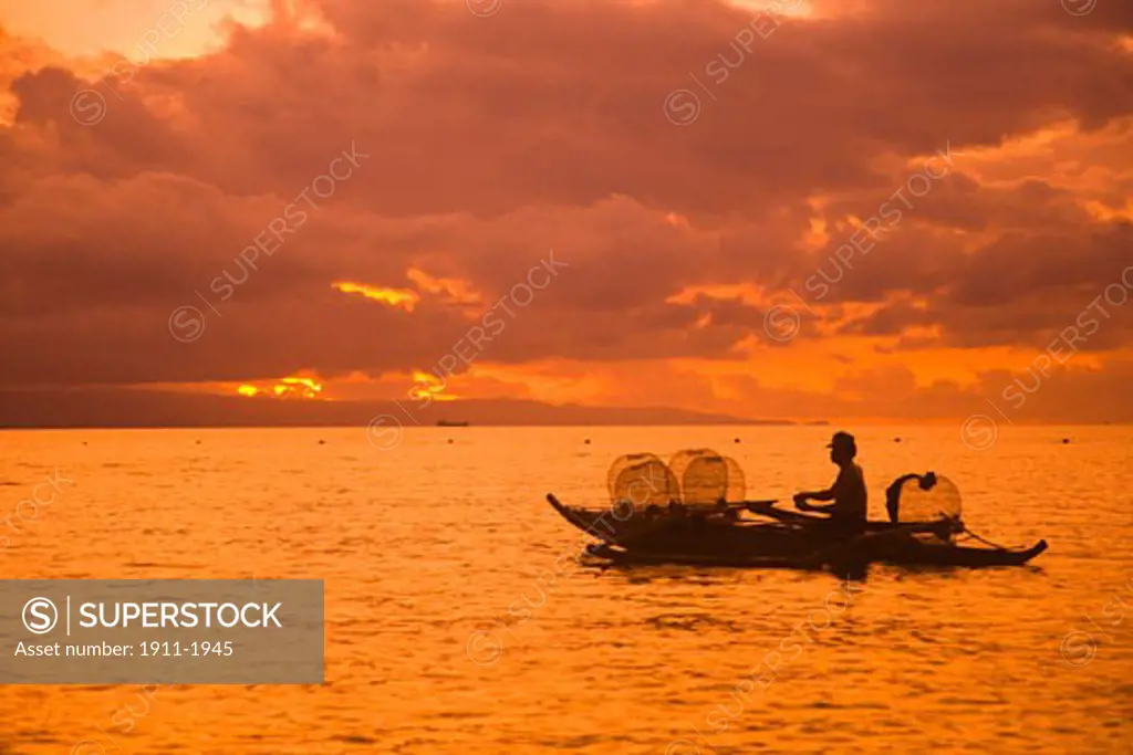 Sunrise   fisherman with baskets  Atlantis Resort Dumaguete   Dumaguete  capital of Negro Oriental Island  Philippines  SE Asia
