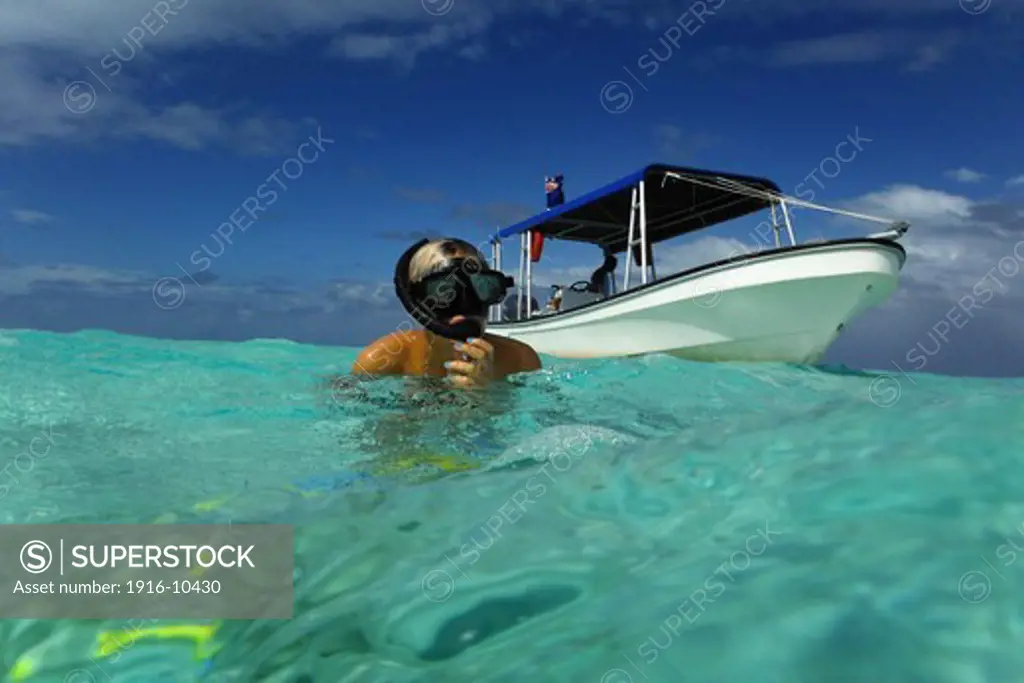 Aitutaki. Cook Island. Polynesia. South Pacific Ocean. Doing snorkeling in the Aitutaki (Lagoon Cruise).   The barrier reef that forms the basis of Aitutaki is roughly the shape of an equilateral triangle with sides 12 kilometres in length.
