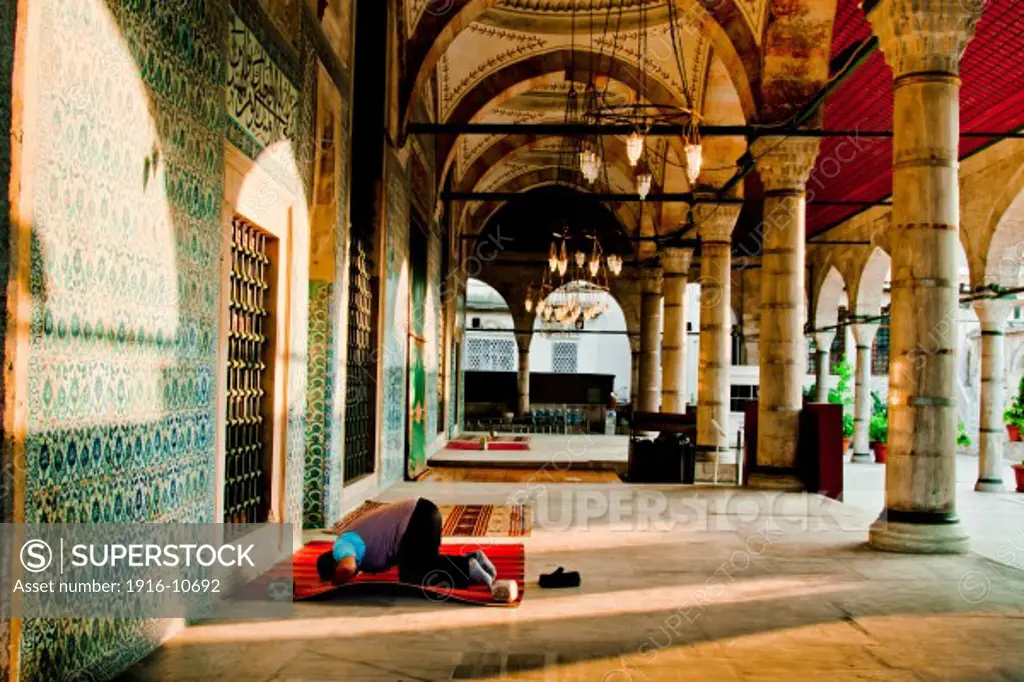 Man praying in Rustem Pasha Mosque. Istanul, Turkey.