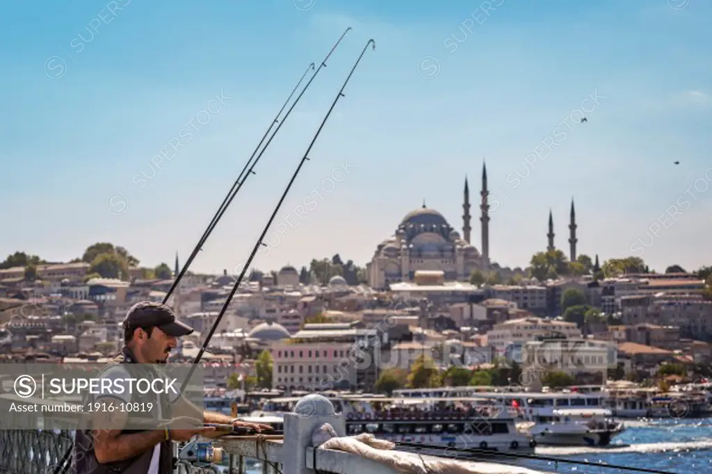A fisherman at the Galata Bridge in Istanbul, Turkey.