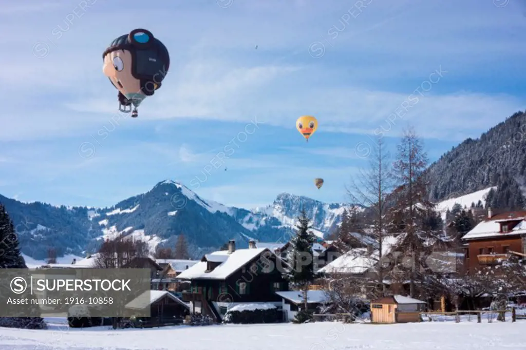 Special form balloons flying over Chateau d'Oex, Switzerland.