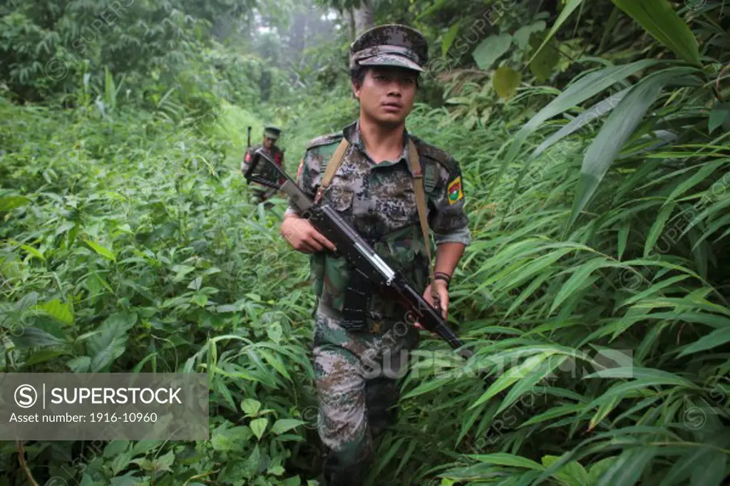 KIA's members walk through the jungle from Naw HPyu Post to Tsinyu Post in the front line war against the Burmese Government, Myanmar on August 2, 2012.
