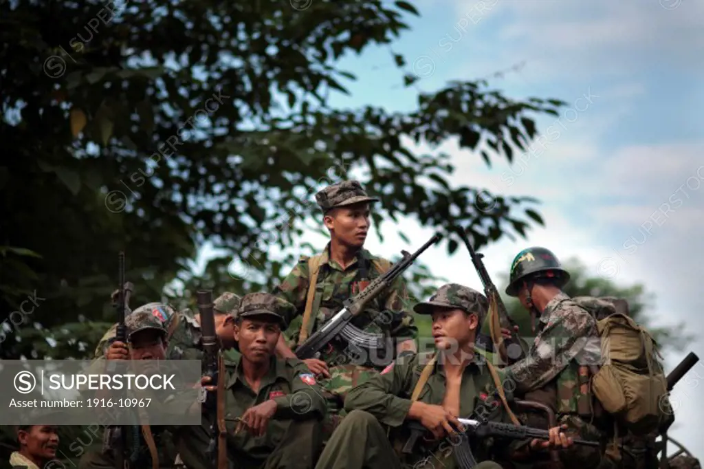 KIA's members wait on the top of a truck for their transfer to other place in the Rubber Hill Post in the front line of Laja Yang village outskirts of Laiza, Kachin State, Myanmar on August 8, 2012.