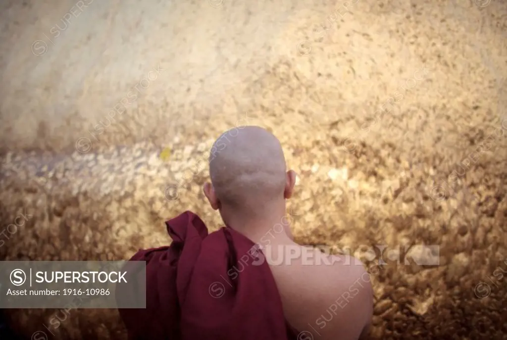 A  Buddhist monk pray in Kyaiktiyo Pagoda 'Golden Rock' in Kyaiktiyo Mon state, Myanmar, Saturday, May 11, 2013.