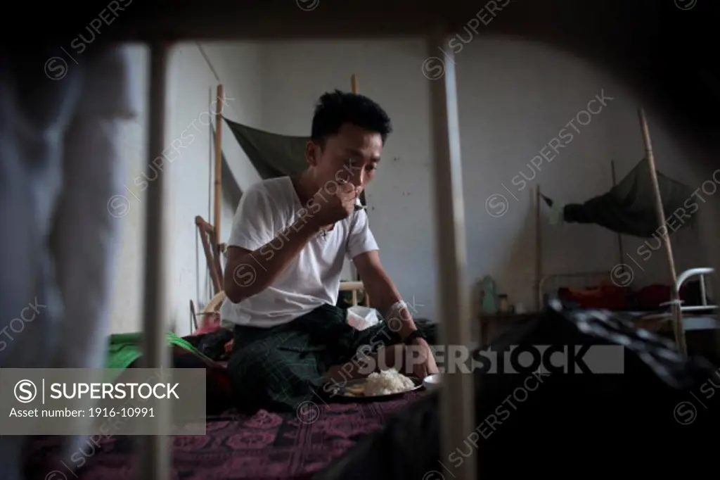 Kachin's militia member Lalaw Ze Dai, from Waimaw village, 25, take the lunch in the General Military Hospital in Laiza village close to the China border, Myanmar on July 26, 2012. He was injured by a landmine in June, 26, 2012 loosing part of his right leg on top of knee.