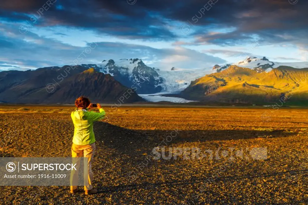 Woman in a mountain landscape in south Iceland.