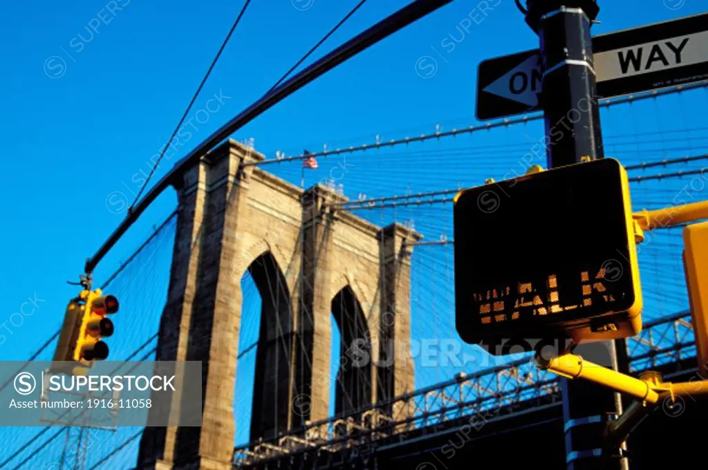 Walk Sign And Brooklyn Bridge; New York City, New York, USA