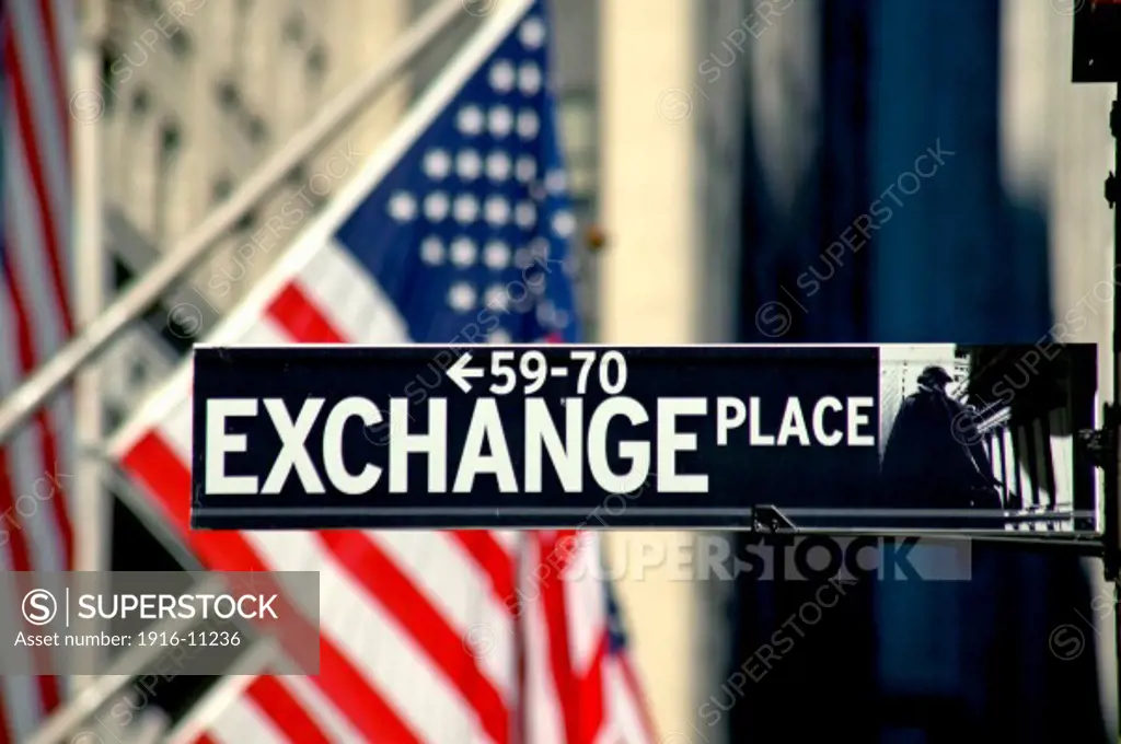 Exchange Place sign and USA flags near the New York Stock Exchange Building on Nassau Street, New York NY