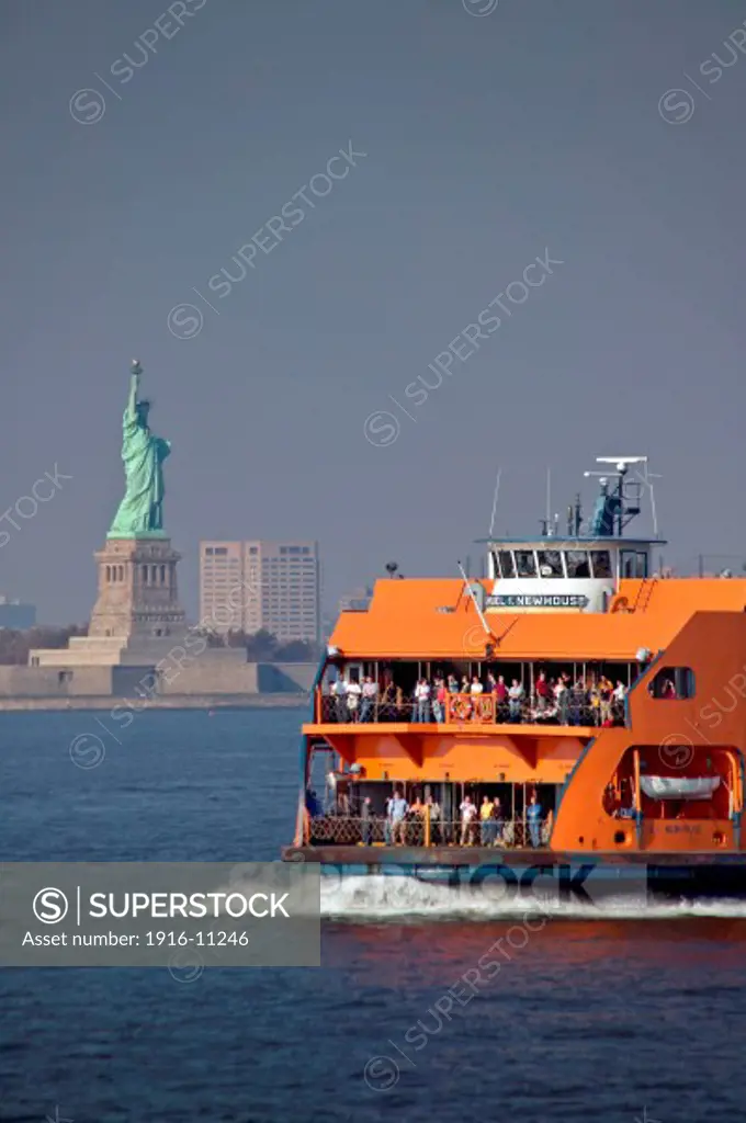 Staten Island ferry on the Hudson River with Statue of Liberty and Hoboken New Jersey skyline in background, New York, NY