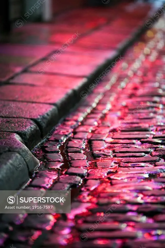 Ireland, Dublin, wet cobblestone road reflecting light