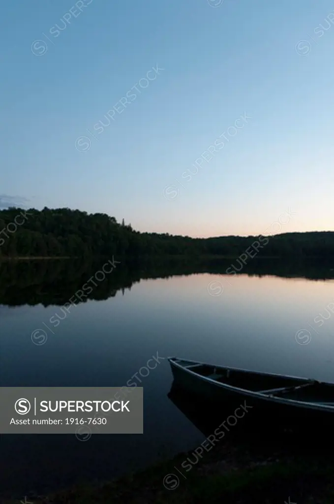 Canada, Ontario, Algonquin Park, boat on calm evening lake