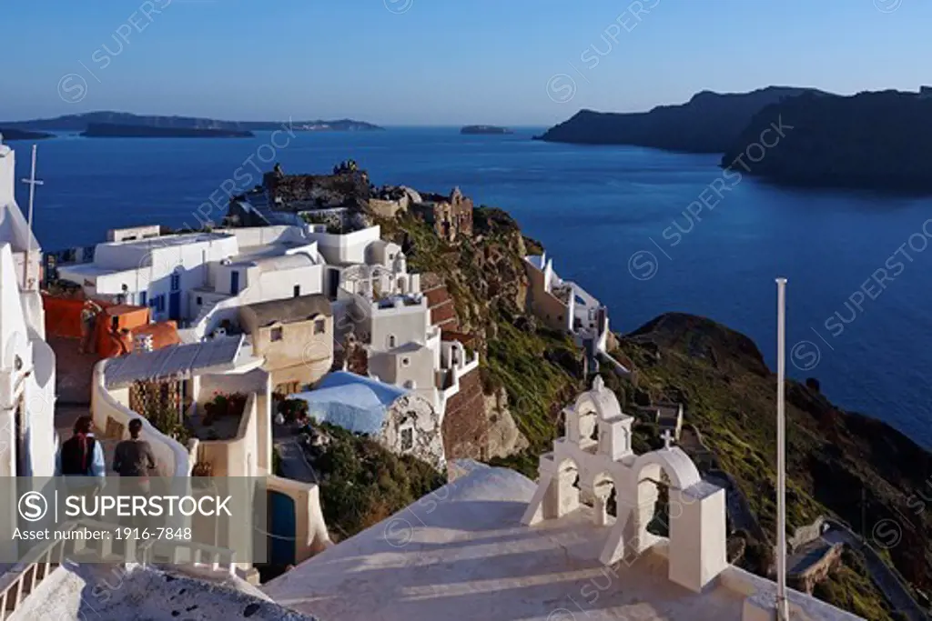 Greece, Santorini, Oia, Sunset from Oia Fortress with Castle of Agios Nikolaos in background