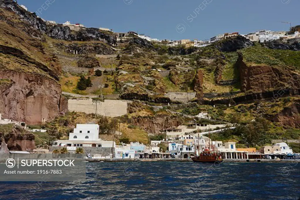 View of the port of Fira and the city on top of cliff from the Aegean Sea, Santorini, Greece